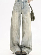 Men’s full size vintage wash wide leg jeans with faded distressed denim and subtle glittery speckles