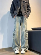 Men’s full size vintage wash wide leg jeans in faded light blue denim with cargo pockets and a relaxed fit