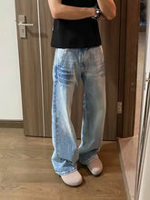 Men’s full size vintage wash wide leg jeans in light wash denim with relaxed fit and subtle distressing details