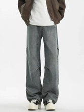 Men’s full size vintage wash wide leg gray denim jeans with a relaxed fit and visible stitching details
