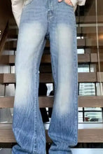 Men’s full size vintage wash light-wash denim wide leg jeans with flared leg cut and subtle fading