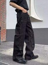 Men’s full size vintage wash wide leg jeans in black denim with cargo pockets and reinforced stitching