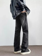 Men’s full size vintage wash wide leg jeans in black denim with visible stitching and a slightly faded vintage wash effect