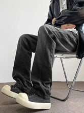 Men’s full size vintage wash wide leg black denim jeans with relaxed fit and visible stitching details