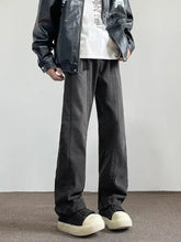 Men’s full size vintage wash wide leg jeans in black denim with a faded vintage wash and visible seam stitching