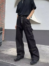Men’s black wide leg jeans with vintage wash featuring cargo pockets, button closures, and reinforced stitching
