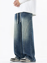 Men’s full size wide leg blue denim jeans with faded vintage wash and white drawstring waistband vintage wash wide leg