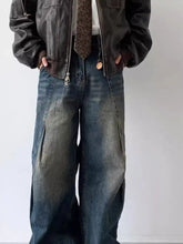 Men’s dark-wash denim cargo pants with faded distressing and visible stitching in a vintage wash relaxed silhouette
