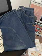 Men’s full size vintage wash wide leg jeans in dark wash denim with curved hem and embroidered patch on thigh