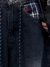 Back side of men’s full size vintage wash wide leg jeans in dark denim with plaid lining visible in back pocket and relaxed silhouette