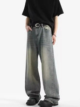 Men’s full size vintage wash wide leg jeans in faded denim with subtle greenish-gray tonal fading and distressed finish