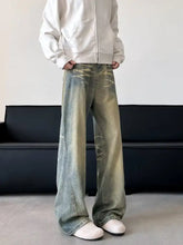 Men’s full size vintage wash wide leg denim jeans with faded distressed look and subtle white stitching details