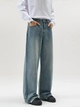 Men’s full size vintage wash wide leg jeans in faded light blue denim with classic stitching and relaxed straight cut silhouette