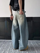 Men’s full size vintage wash wide leg jeans in faded light blue denim with subtle distressing and classic back pocket design