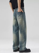 Men’s full size vintage wash wide leg jeans in denim with a faded gradient wash from dark blue to light beige
