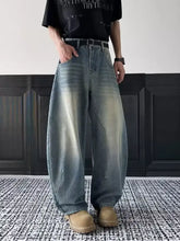 Men’s full size vintage wash wide leg jeans in faded light blue denim with subtle distressing details
