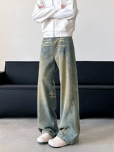 Men’s full size vintage wash wide leg denim jeans with a faded distressed look and subtle blue green tie dye patterns