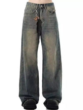 Men’s full size vintage wash wide-leg jeans in faded distressed dark denim with subtle fading and whiskering details