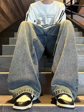 Men’s full size vintage wash wide leg jeans in faded blue denim with rolled cuffs and a vintage wash wide design