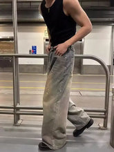 Men’s full size vintage wash wide leg jeans in faded gray denim with subtle distressing and paint-splatter details