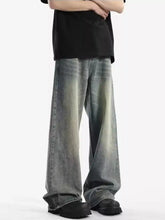 Men’s full size vintage wash wide leg jeans in faded gray denim with subtle distressing and raw hem detailing