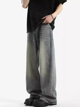 Men’s full size vintage wash wide leg jeans in faded gray denim with subtle distressing and frayed hems