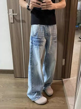Men’s light-wash denim full size vintage wash wide leg jeans with relaxed wide leg cut and subtle distressing details