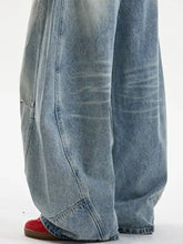 Men’s full size vintage wash light-wash denim jeans with a relaxed wide leg cut and visible stitching details