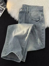Men’s full size vintage wash wide leg light-wash denim jeans with a faded distressed look and frayed hem