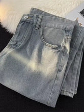 Men’s full size vintage wash wide leg light-wash denim jeans with a faded, distressed vintage wash look