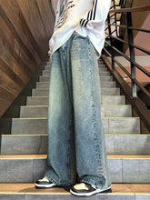 Men’s full size vintage wash wide leg jeans in light blue denim with classic stitching and a relaxed fit