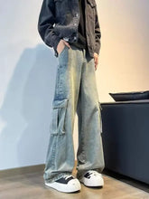 Men’s full size vintage wash wide leg jeans in faded light blue denim with prominent cargo pockets