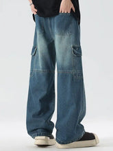 Men’s full size vintage wash wide leg jeans in faded blue denim with multiple cargo pockets for functional style