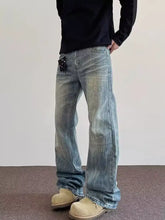 Mens full size vintage wash wide leg jeans in faded blue denim with subtle distressing details