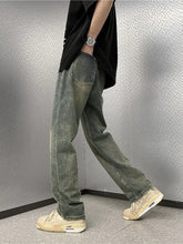 Men’s full size vintage wash wide leg jeans in faded olive green denim with classic stitching and relaxed straight-leg cut