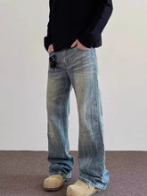 Men’s full size vintage wash wide leg jeans in washed blue denim with a relaxed, wide leg cut and subtle fading