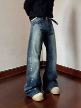 Men’s full size vintage wash wide flare denim jeans in blue with white paint splatter details and vintage wash finish