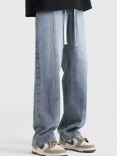 Men’s light-wash denim vintage wash wide leg jeans with relaxed straight cut and white drawstrings at the waist