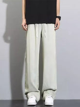 Men’s full size vintage wash wide leg jeans offer a relaxed fit with light green jogger style and white drawstrings