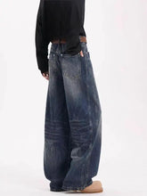 Men’s full size vintage wide leg dark blue denim jeans with faded wash and visible stitching in wide leg jeans style