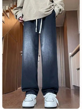 Men’s dark-wash loose fit jeans with relaxed straight-leg cut and white drawstrings in plus size fit jeans
