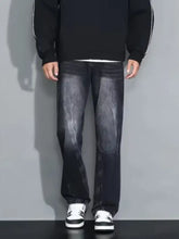 Men’s black denim loose fit plus size jeans with faded watercolor wash and subtle whiskering details