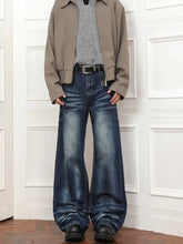 Men’s full size wash loose fit jeans in medium blue wash denim with subtle fading and classic five-pocket design