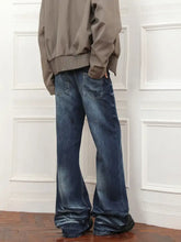 Men’s dark blue denim full size wash loose fit jeans with wide-leg flared cut and subtle fading details