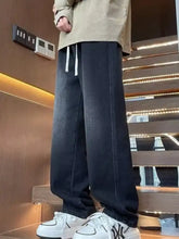 Men’s dark-wash denim loose fit jeans with white drawstrings and a relaxed straight-leg cut in full plus size