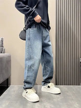 Men’s light-wash denim jogger pants with loose fit relaxed tapered style and elastic cuffs in full size wash loose design