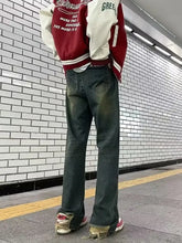 Back view of red and white varsity jacket with gree lettering paired with men’s loose fit plus size jeans