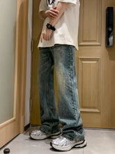 Men’s full size wash loose fit jeans in faded blue denim with subtle distressing and wide-leg loose fit design