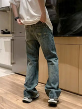 Men’s full size wash loose fit blue denim jeans with faded wash and decorative embroidery on the back pocket view