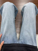 Men’s full size wash relaxed fit jeans in light-wash denim with straight-leg cut and visible stitching details